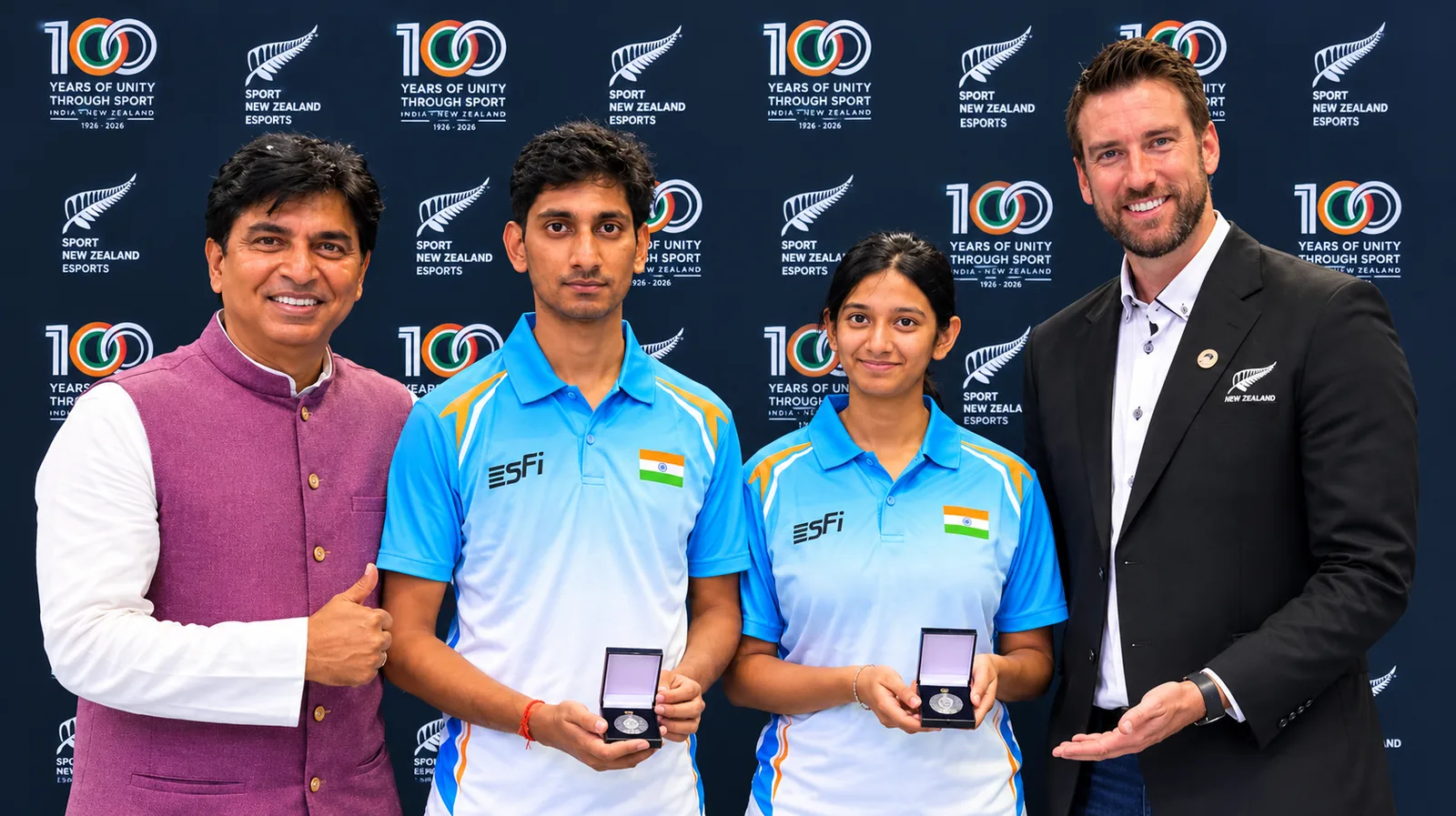 Indian eFootball players Chinmay Sahoo and Dr Abirami Iyer pose with officials after India's 2-1 esports series victory over New Zealand in Auckland.