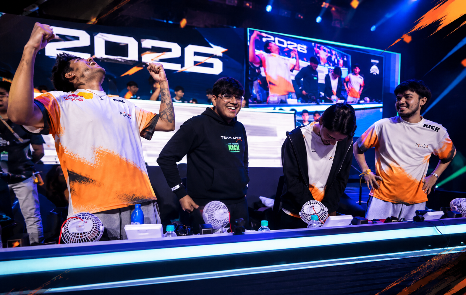 BGMI esports players celebrating on stage during BMSD 2026, with one player raising his fists as teammates react behind the competition desk.