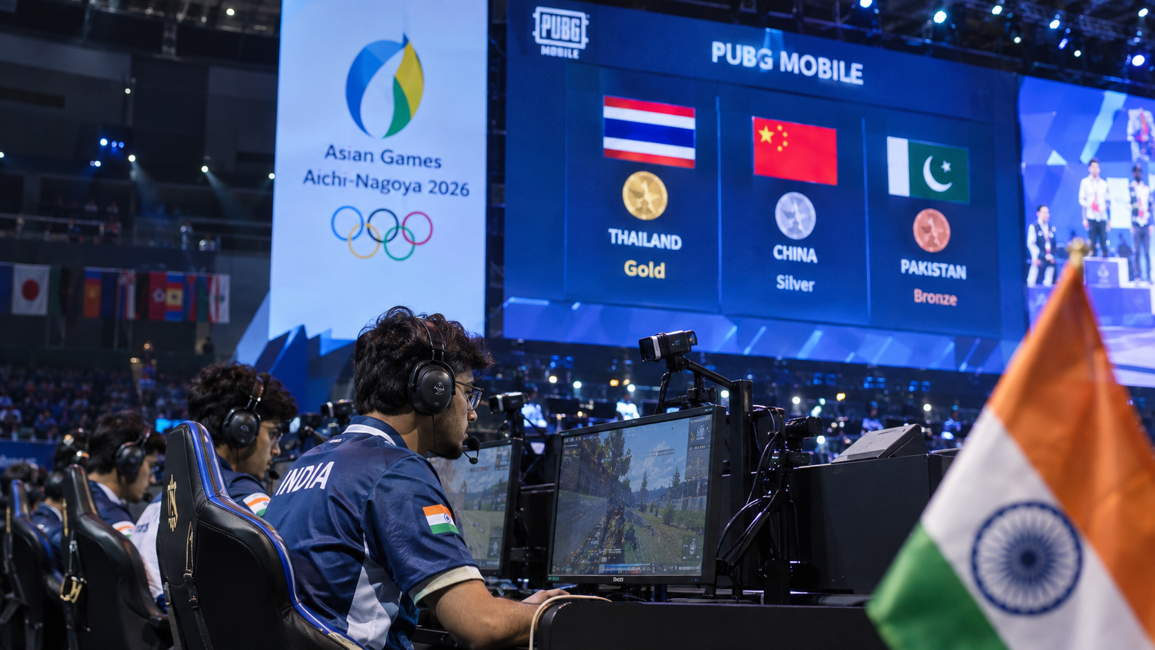 Indian esports players competing at the Asian Games 2026 in an arena, with the PUBG Mobile medal standings shown on a large screen.